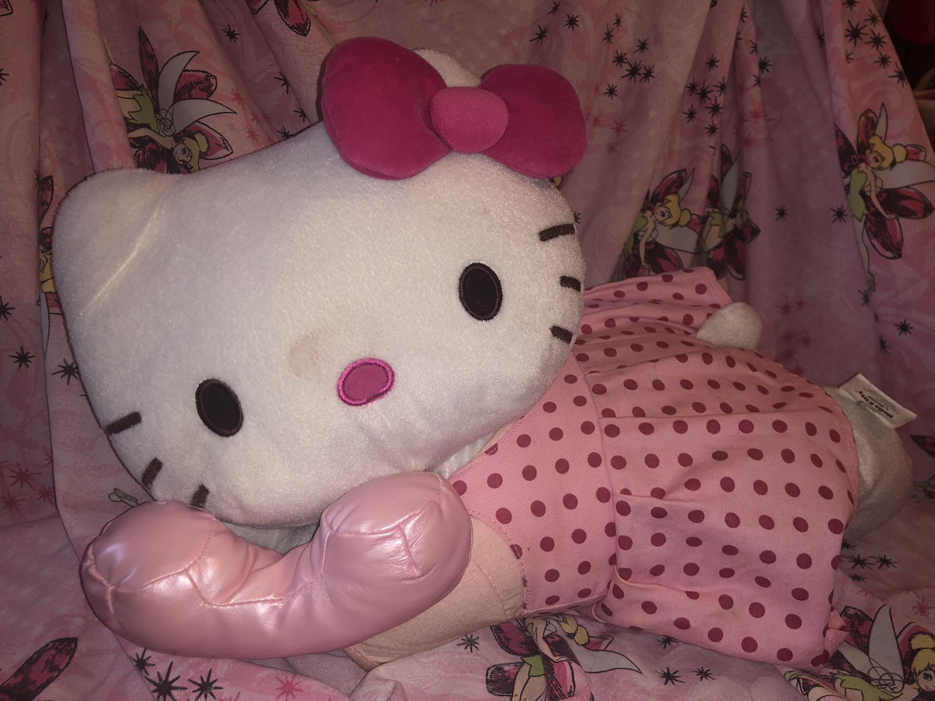 Jumbo hello kitty plush stuffed animal doll on pink phone laying on tummy , pink poka dot dress and pink bow in hair . Sanrio 18” long! 12” high!