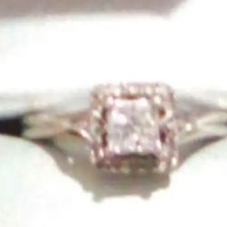 14 K White Gold Princess Cut Diamond Ring With Diamonds Wrapped Around It 