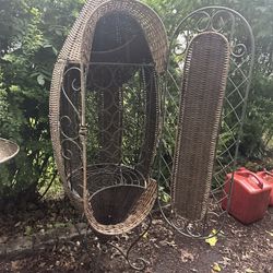 Unique wicker hanging chair with metal stand.