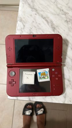 Red Nintendo 3 DS with 2 games, Zelda case, and Zelda stylus
