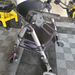 Heavy-duty Grey rollator walker with a seat, which converts to a transport chair.