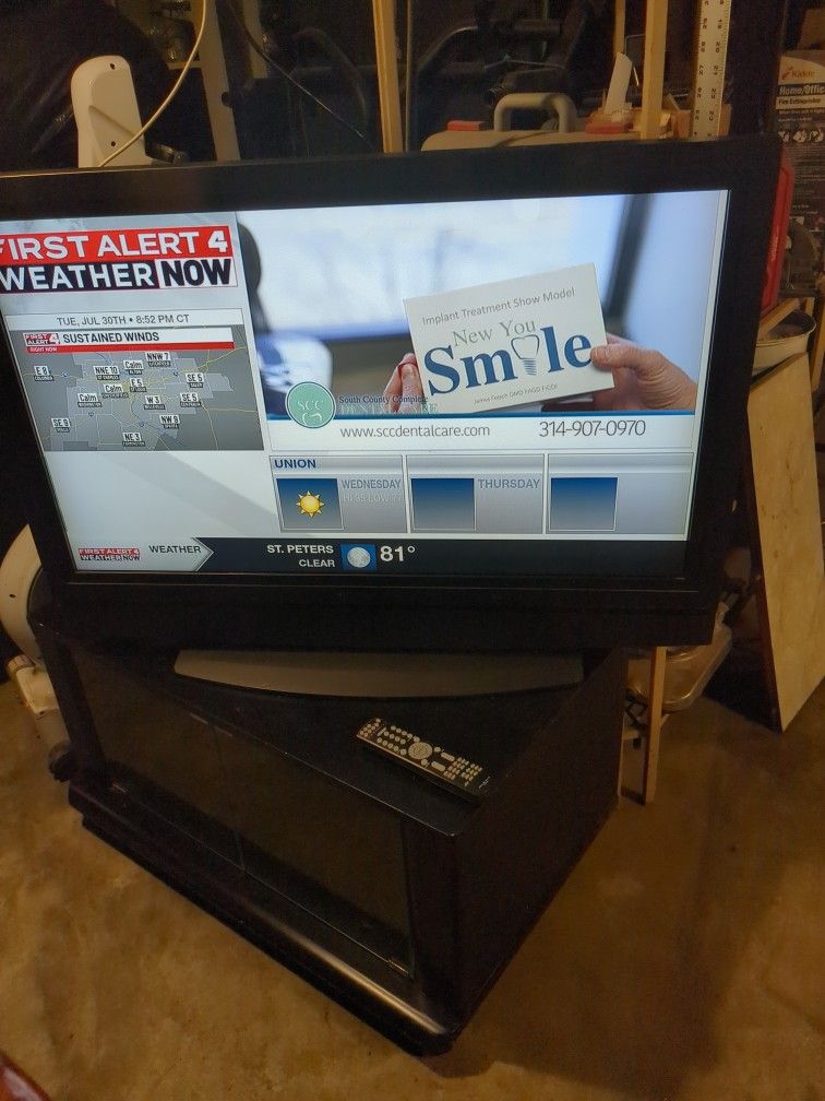 42 Inch Older Model Olevia With Lots Of Feathers Come With Tv Stand And Remote, It's All Good.
