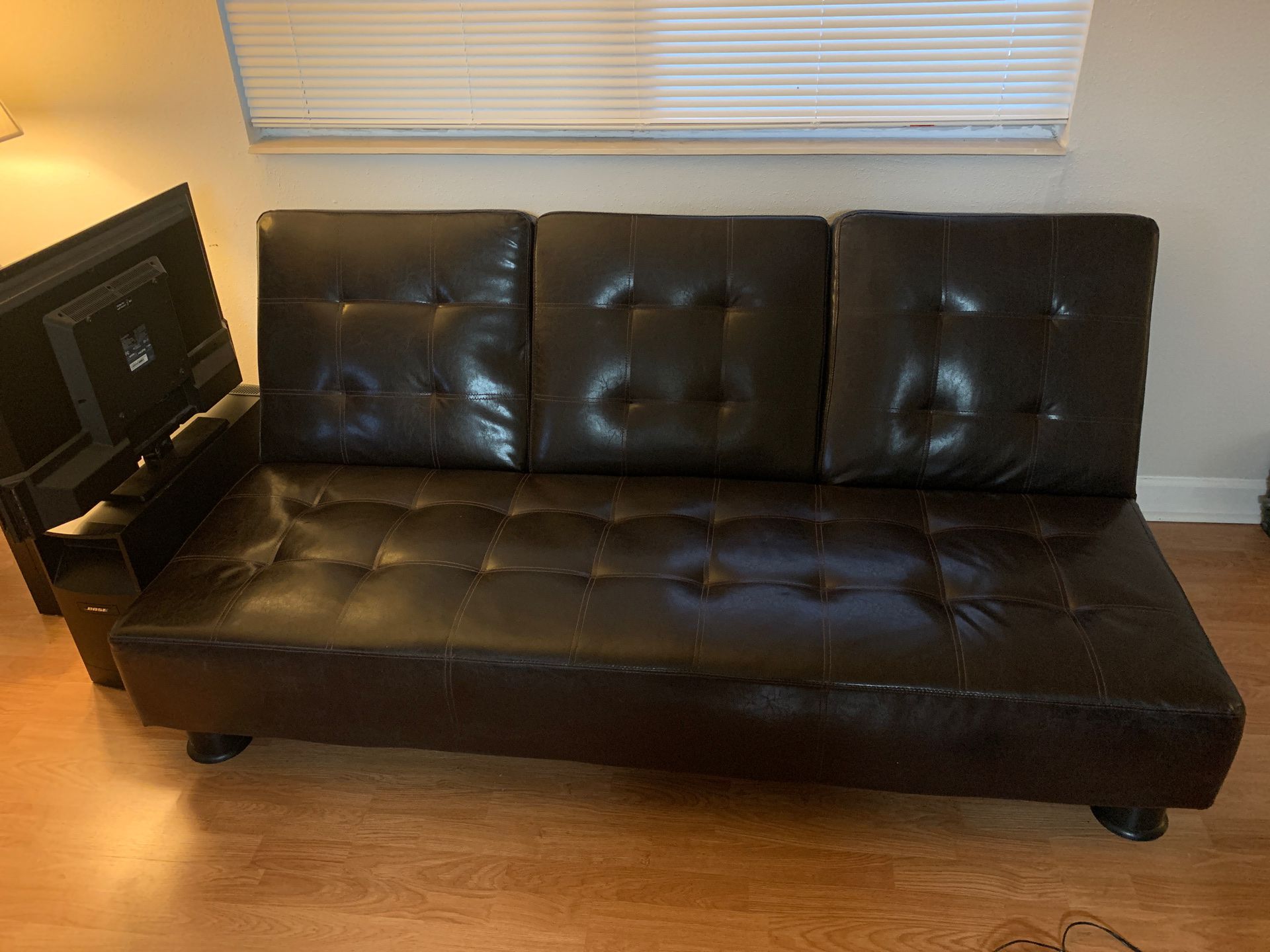 Reclinable leather futon. Good condition.
