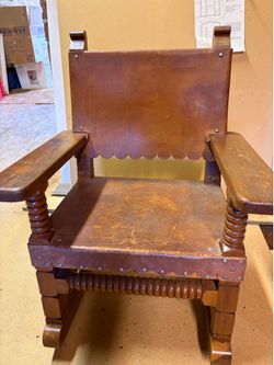 Antique child’s wood and leather rocker