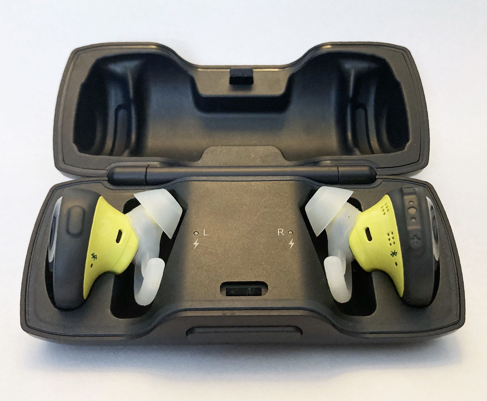 Bose SoundSport wireless headphones with charging case.
