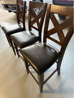 (3) solid wood barstools with leather cushions