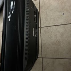 flat screen TV (older model, maybe 32”–40”).