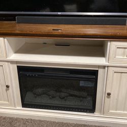 Nice Slightly Used Large Entertainment Console with electric Fireplace. Has Two Cabinets With Shelf Inside 