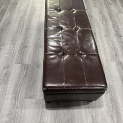Tufted brown leather ottoman in good condition.
