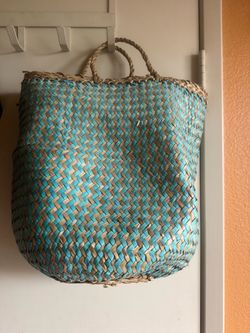 Handwoven straw tote in turquoise and natural tan.