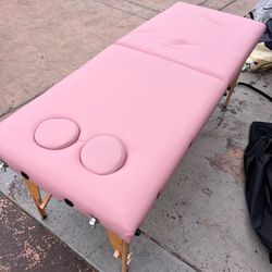 Pink portable massage table with ergonomic spacing