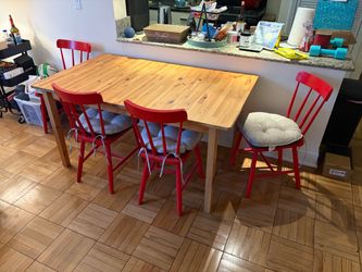 Wooden Dining Room Table w/ Red Cushioned Chairs