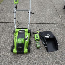 Green works electric cordless lawn mower with free electric weed eater.