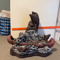 Statue. Indian In Canoe