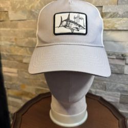 The Guy Harvey Sea Worlds Trucker Hat Cap in grey and white is a stylish accessory perfect for outdoor enthusiasts. Made by White, this one-size-fits-