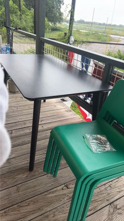 Table with 4 green chairs