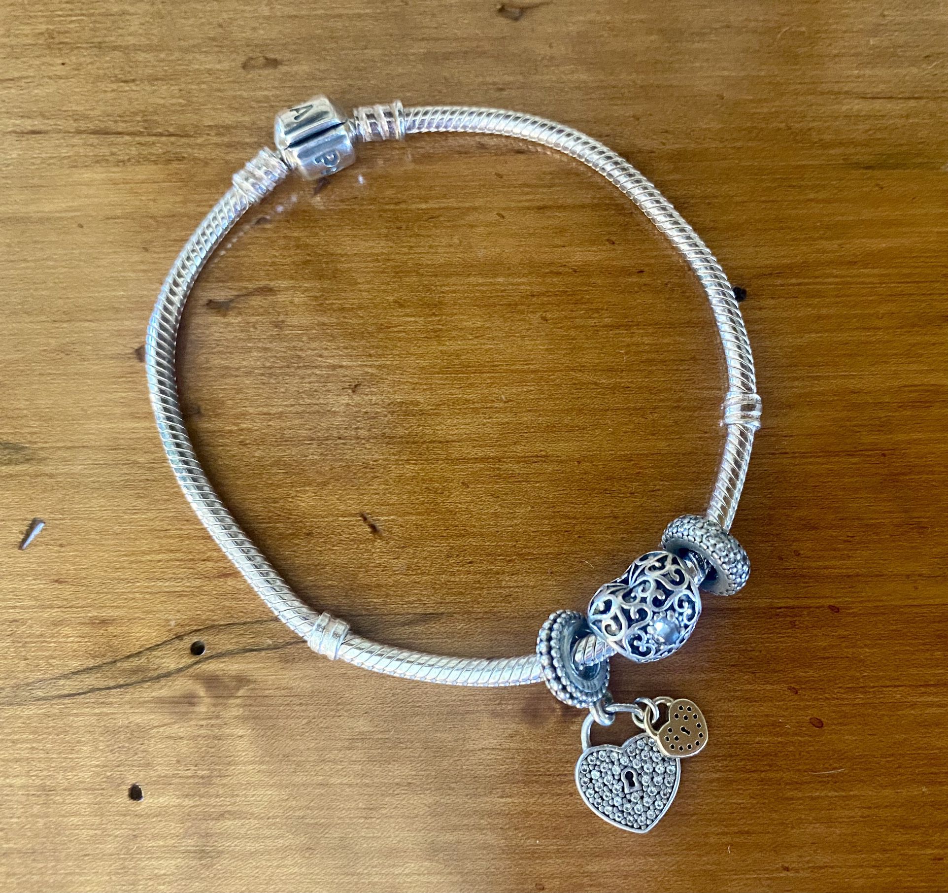 Pandora sterling silver snake bracelet with three charms