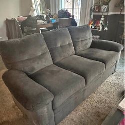 Dark blue couch with matching armchair