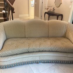 Gorgeous vintage and antique style upholstered sofa in a velvet diamond fabric with fringes