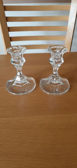 Set of two clear glass candle holders.