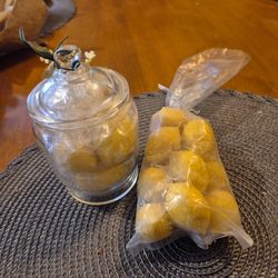 Apothecary jar filled with soap and extra bag of soap