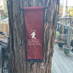 Black and red hanging cloth sign with saying