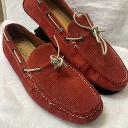 Pair of Size 8 Men Red Suede Driving Loafers by Aldo featuring a textured rubber sole. Suede upper with textured finish. Moc toe stitching and leather