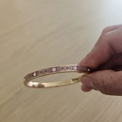 Coach bracelet Gold and Pink.