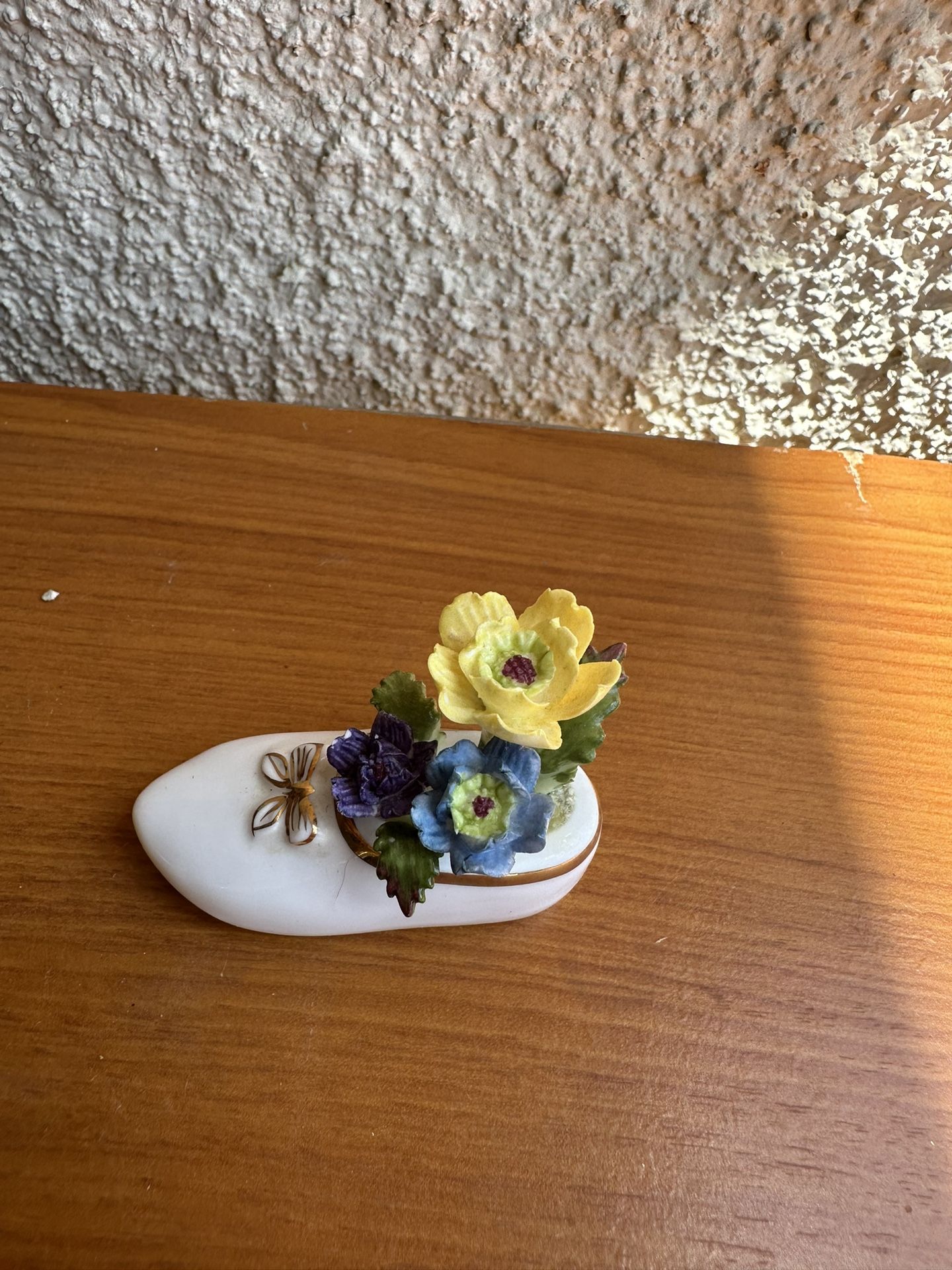 Masterpiece Bone China miniature shoe figurine, often adorned with flowers