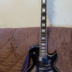 LEO JAYMZ SINGLE CUT DELUXE ELECTRIC GUITAR MAHOGANY BODY LAUREL BOARD DUAL HUMBUCKERS SKULL DESIGN. 