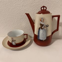 chocolate maid, teapot, cup and saucer for tea