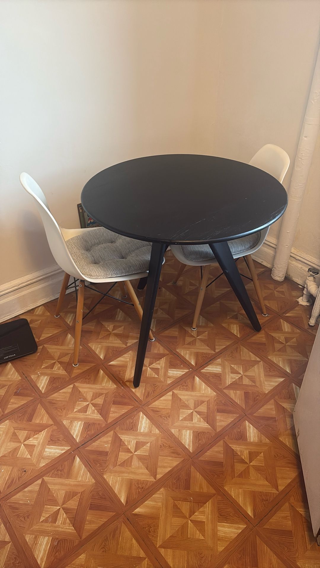 3 Leg Black Table W/ Two White Chairs & Cushions