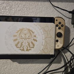 Nintendo Switch OLED Zelda Edition with Joy-Cons, cables, Dock, and Wall Mount.