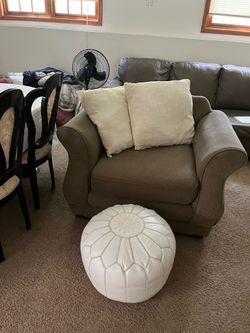 Mini brown couch, with beige pillows, white foot cushion