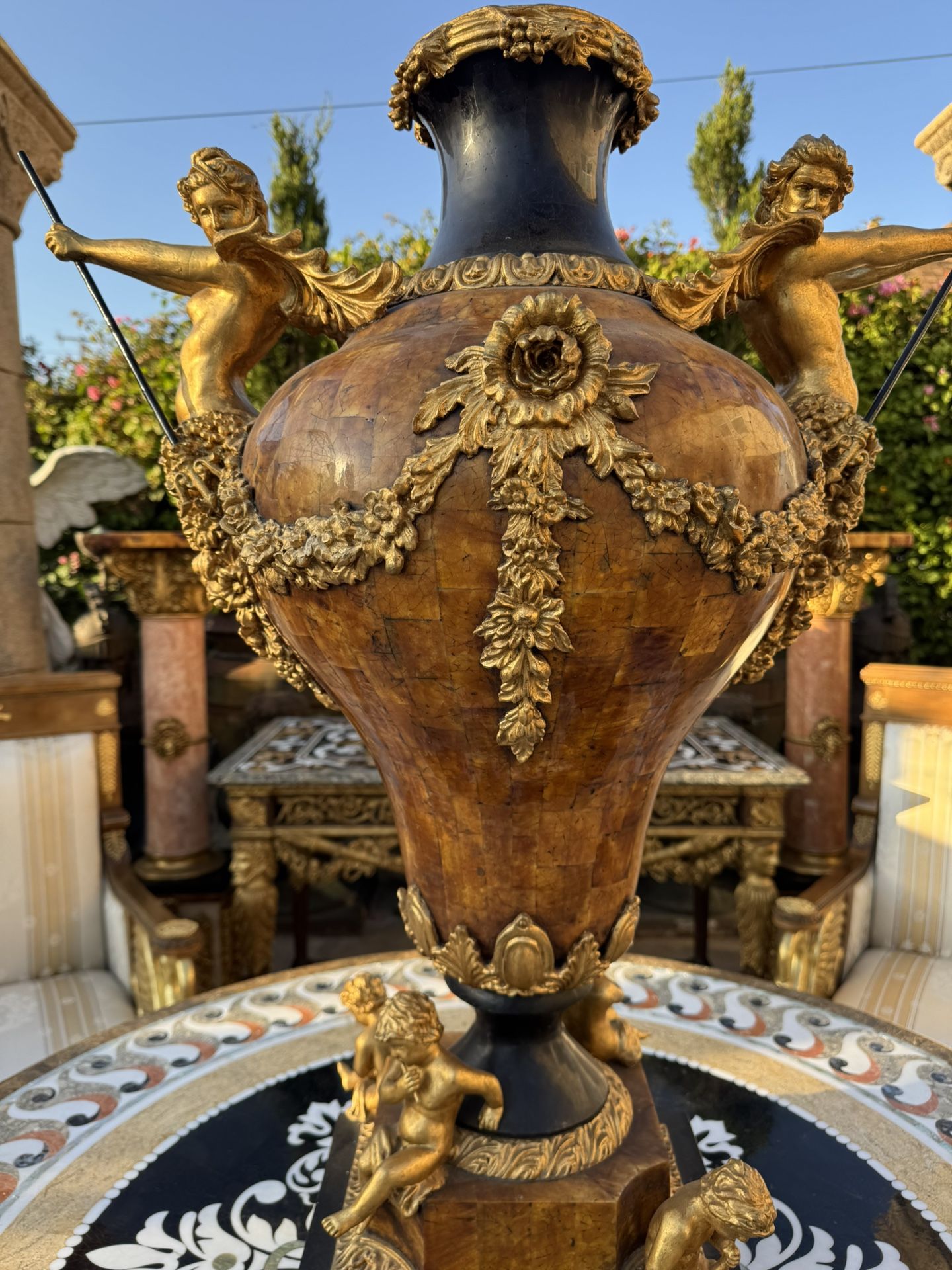 Pair of Italian Neoclassical urns with Mythological and Gold Cupid Figures