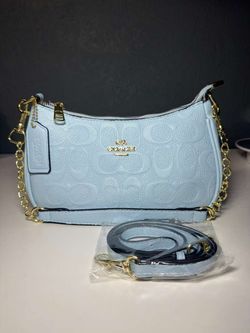 Coach light blue embossed monogram mini shoulder bag