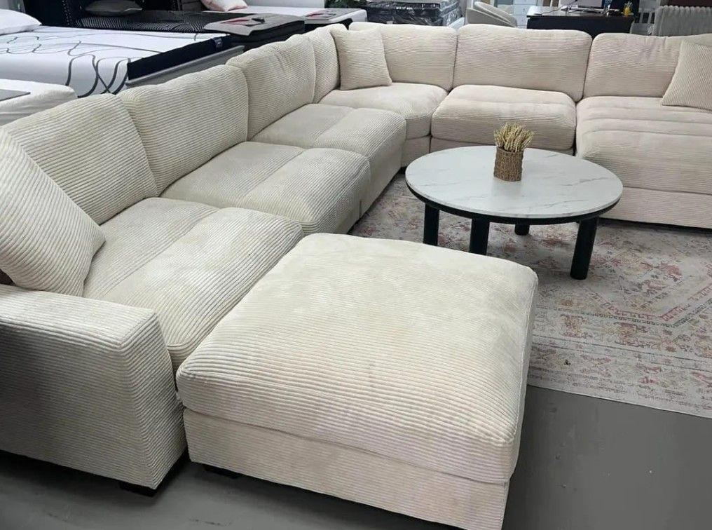 7Pc Beige corduroy sectional sofa with ottoman