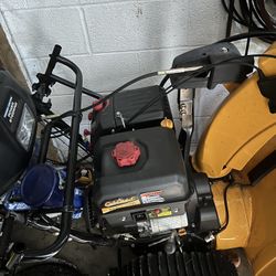 Cub Cadet snow blower, specifically a two-stage model with an IntelliPOWER® engine. 