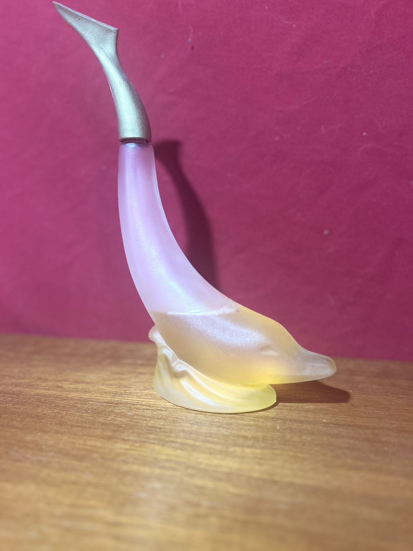 vintage Avon bottle shaped like a dolphin.