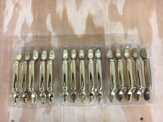 Gold handles for kitchen cabinets and drawers.