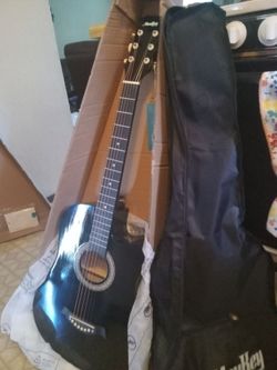 New guitar in box with gig bag and accessories
