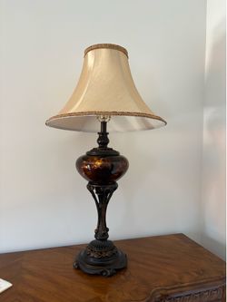 Barnes and Ivy Liam traditional table lamp features a distinctive tortoise shell glass font and a warm Florentine bronze finish