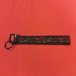 Handmade keychain black red flower plaid on back 