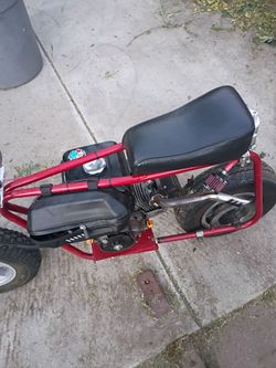 Mini bike color is powder red  coated weighs 100 pounds.