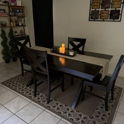 Chocolate brown dining table with four chairs