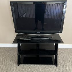 Tv With Black And Glass Stand