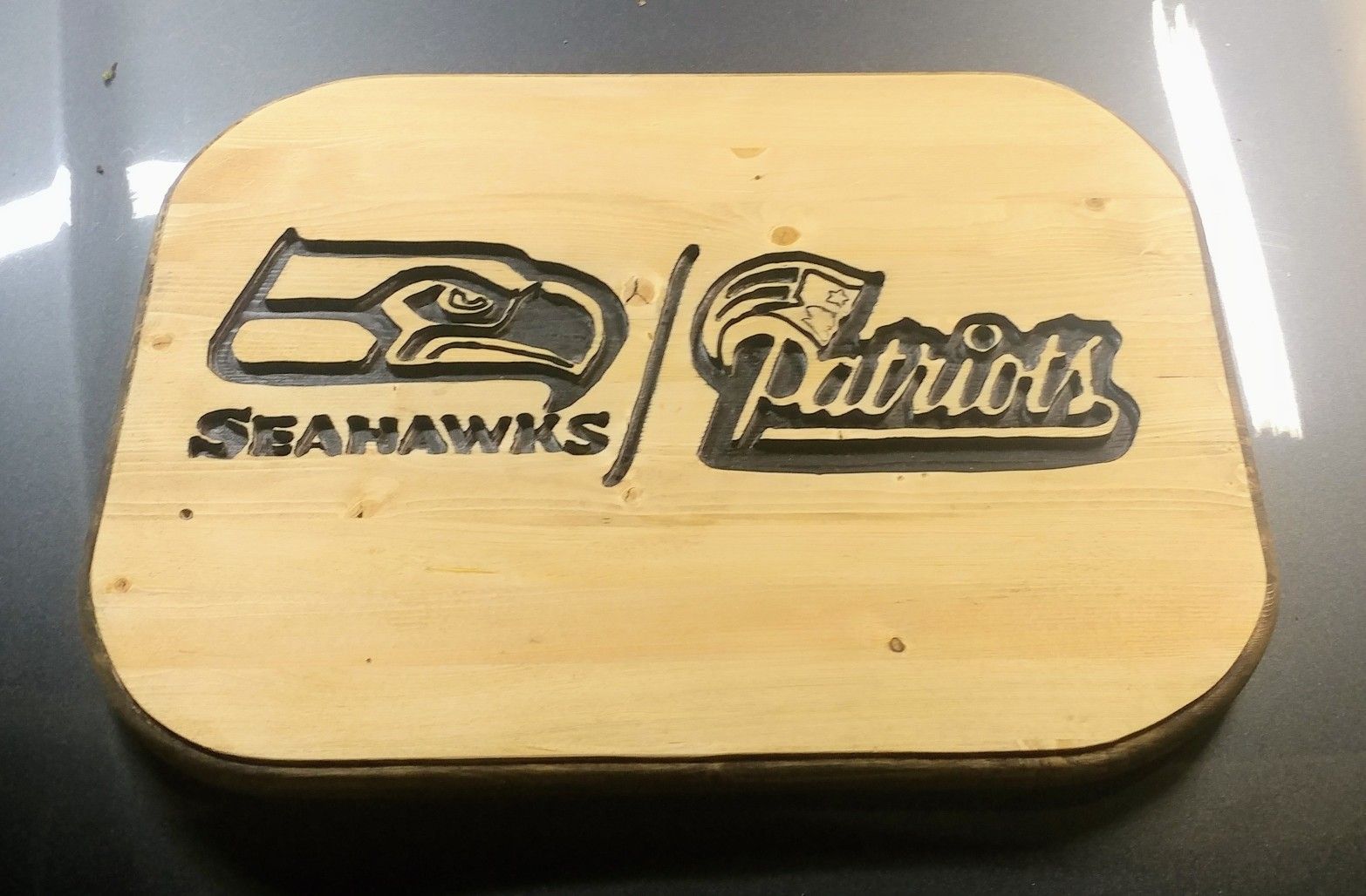 Wood sign seahawks vs patriot fans