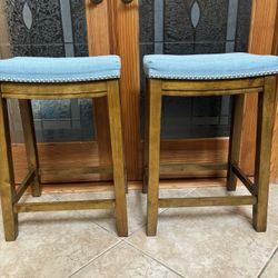 Comfortable saddle-style Bar Stools wood finish and blue upholstered seats w/ nailhead trim 