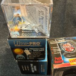 Brand new baseball and hockey puck holders