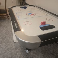 Air Hockey Table With Two Handles And A Puc